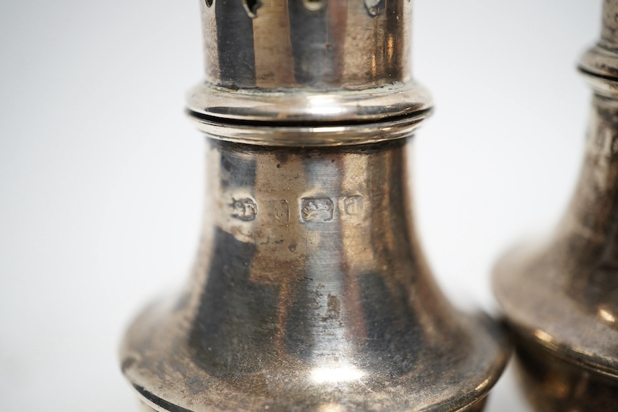 A collection of small silver to include two pepper pots, a mustard pot, a small hip flask, a pair of sugar tongs, a set of five Victorian fiddle pattern teaspoons, two other spoons and a butter knife, 544g gross. Conditi